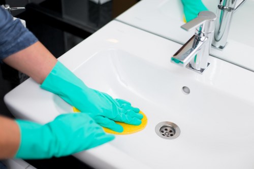Professional office cleaner preparing meeting rooms in Chiswick